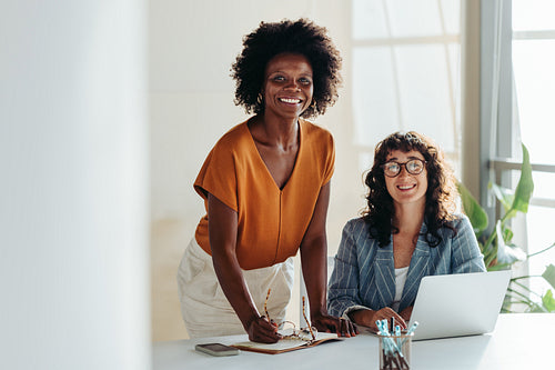 Diverse female entrepreneurs collaborating in a modern office setting