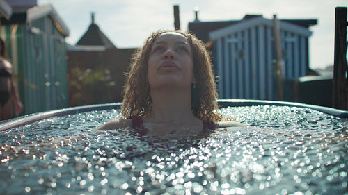 Morning therapy with a woman in an outdoor ice bath for recovery