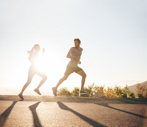 Young people running on country road