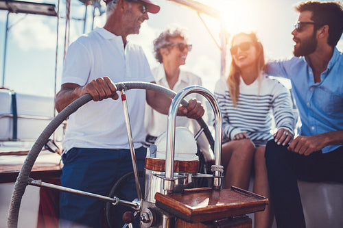 Family relaxing on yacht for holidays