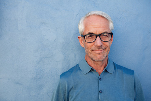 Handsome senior man with glasses looking at camera