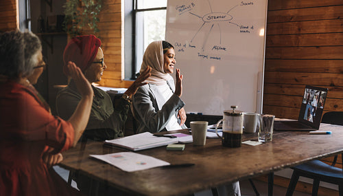 Group of happy businesswomen having an online meeting in an offi