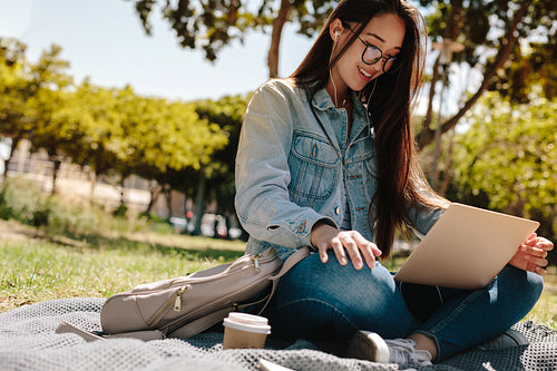 Girl in college campus using a laptop