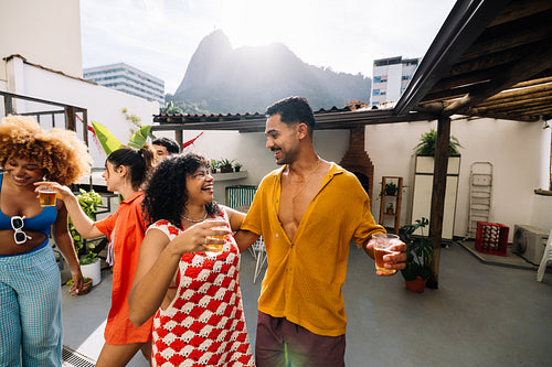 Group of friends socializing at a rooftop party in Rio de Janeiro