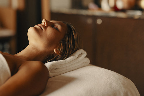 Woman enjoying facial beauty treatment at spa