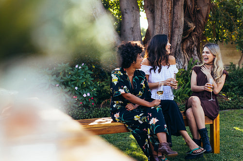 Cheerful young women hanging out with drinks