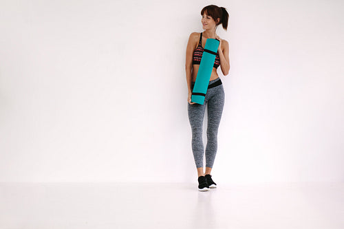 Sporty woman relaxing after yoga class