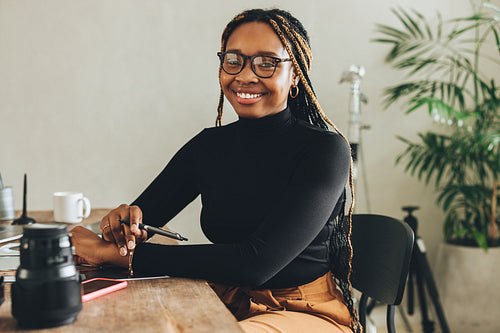 Creative young woman smiling at the camera
