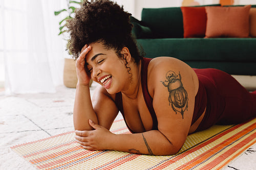 Fitness woman taking break from yoga workout and smiling