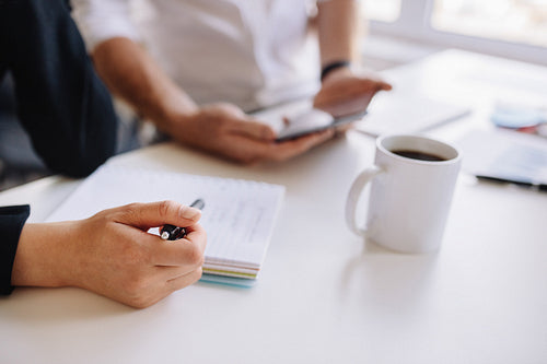 Businesswoman working at office with associate