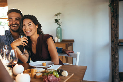 Couple having dinner party with friends taking selfie
