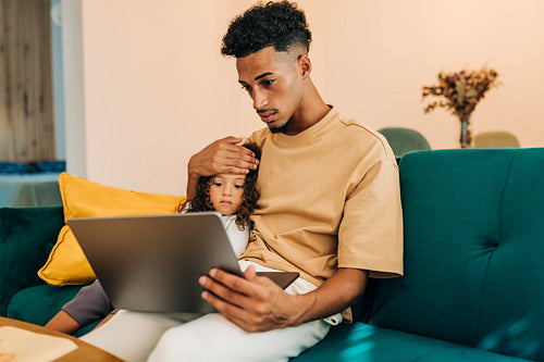 Father and daughter having an online consultation with a doctor