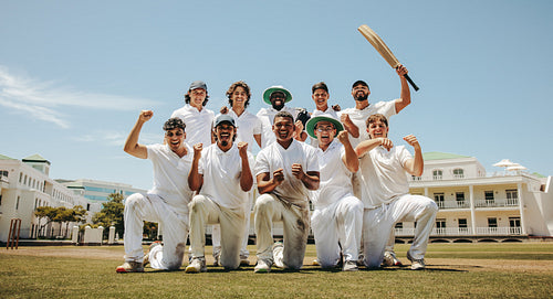Happy cricket team celebrating on a sunny day outdoors