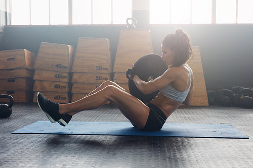 Energetic woman doing abdominal exercise