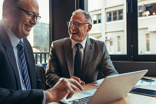 Cheerful business partners having meeting at the cafe