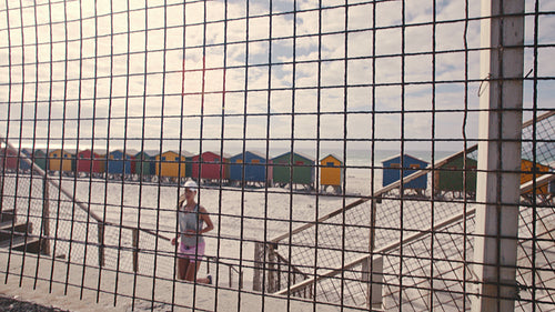 Woman running up the steps on beach