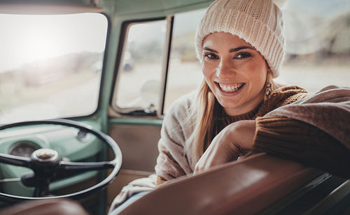 Happy woman travelling by van