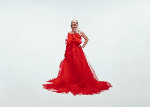 Beautiful senior woman in a glamarous red gown