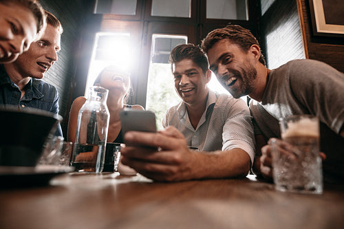 Friends sharing some photos on smart phone