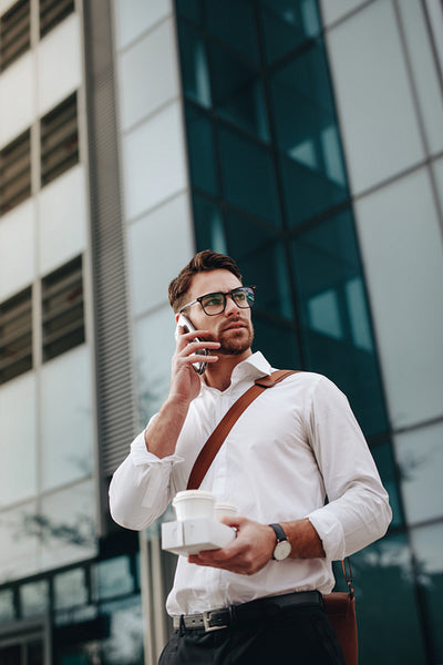 Entrepreneur talking on cell phone while walking on street