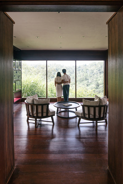 Couple in hotel room enjoying view from window