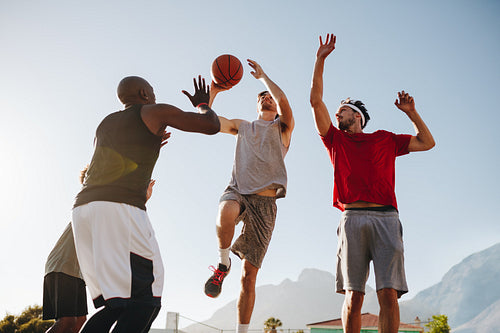 Men playing basketball
