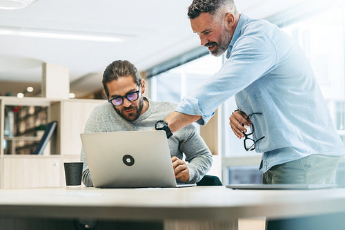 Two entrepreneurs sharing business ideas in an office