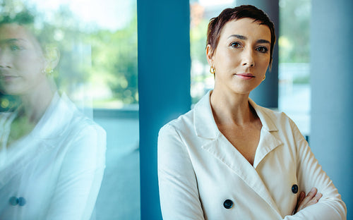 Confident businesswoman with short hair in modern office