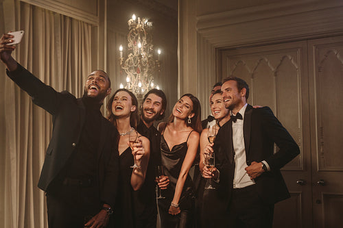 Group of people taking a selfie at party