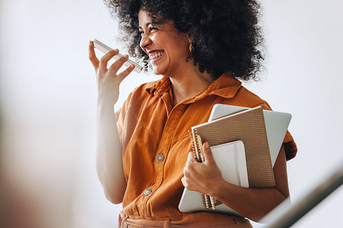 Happy businesswoman smiling while taking a phone call