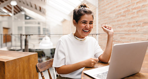Happy female entrepreneur having an online meeting in her office