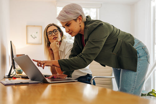 Young businesswoman collaborating with her colleague in an offic