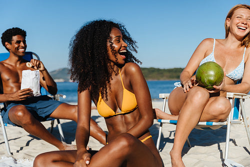 Friends basking in the warmth of friendship and enjoying a beach day