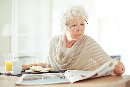 Senior Woman Reading the Morning News