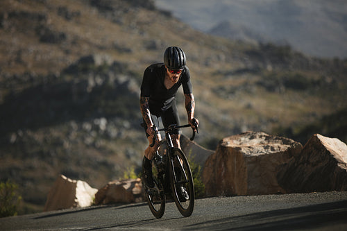 Determined sportsman pedals uphill 