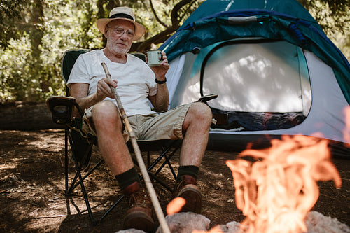 Senior having leisure time at campsite