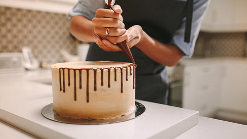Pastry chef decorating a cake