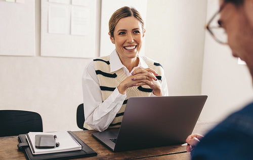Female hiring manager interviewing a job candidate in her office