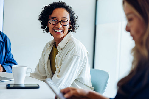 Businesswoman smiles during business meeting