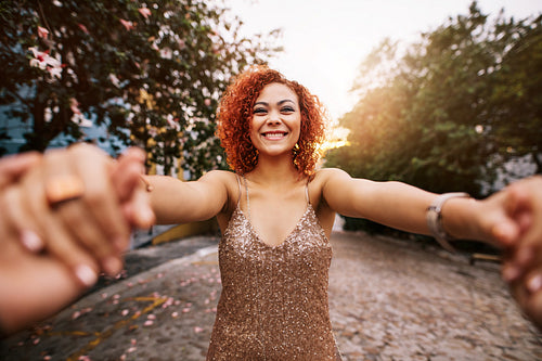 Happy young woman in a romantic mood with her partner on a street.