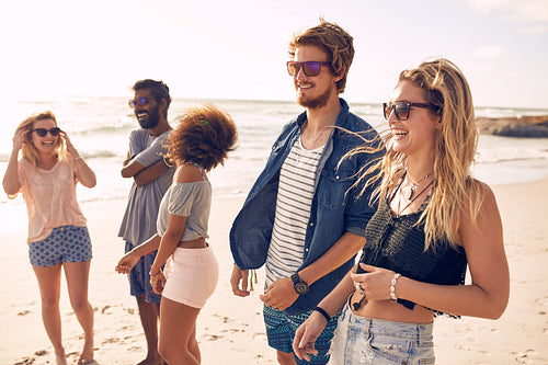 Group of friends having fun on the beach