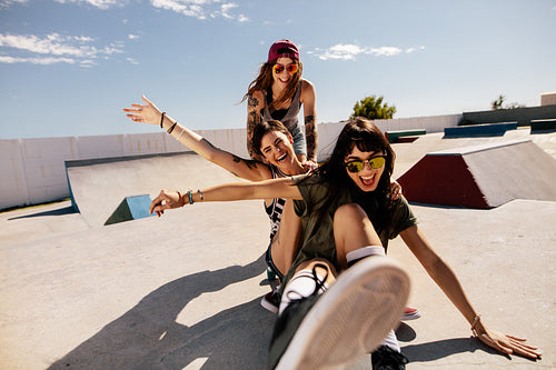 Friends playing with skateboard at the skate park
