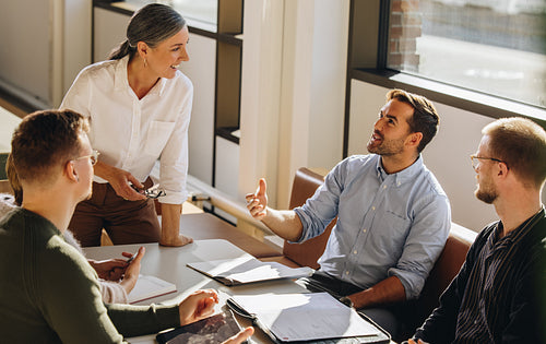 Executive talking to female entrepreneur during meeting