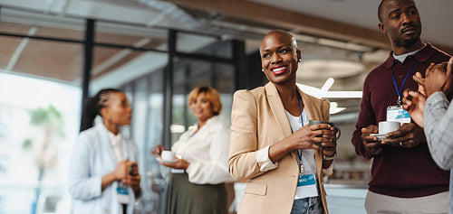 Professional colleagues networking at conference break with coffee