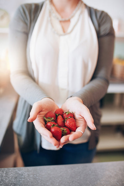 Woman's hands holding strawberries