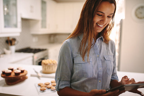 Pastry chef using digital tablet in kitchen