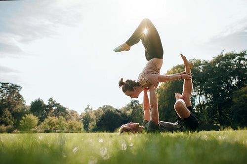 Couple doing acro yoga in pair