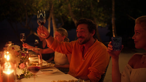 Happy family enjoys a beautiful candlelit dinner at an exclusive island resort