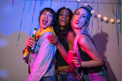 Three women having fun at a house party