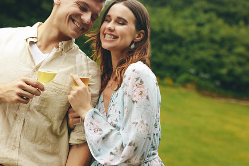 Beautiful couple at the park with champagne